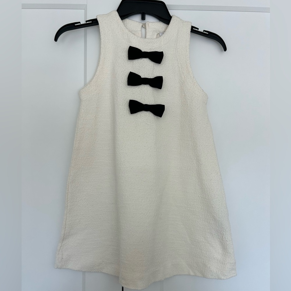 Charming White Sleeveless Kids Dress with Black Bow Accents